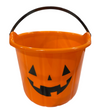 Orange Halloween candy bucket with a black handle and jack-o'-lantern face design on a white background.
